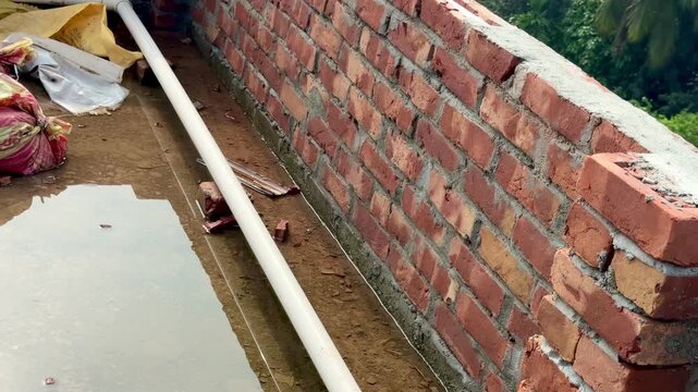 Rooftop Brick Parapet Wall Construction with PVC Drainage Pipe Installation