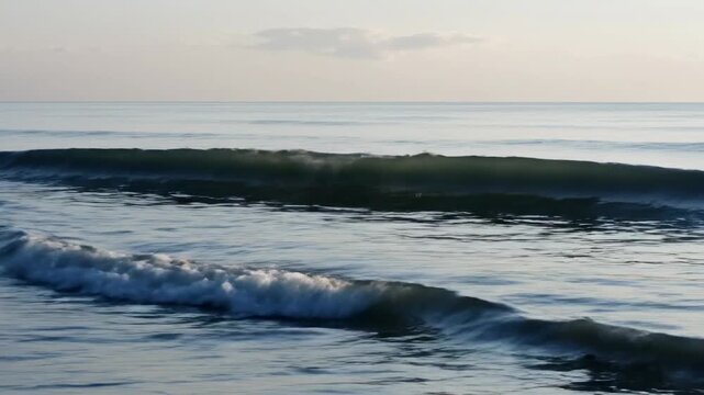 Waves rolling on a beach during the early morning hours at a calm seaside location
