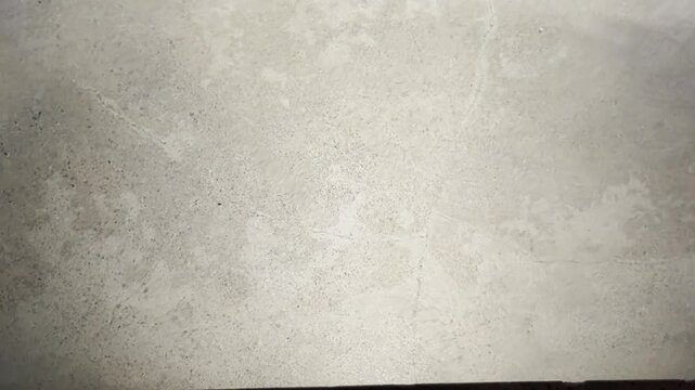 Abstract water reflections moving across a minimalist grey concrete pool floor with large copy space for luxury branding, architecture, wellness, travel, and motion graphics.