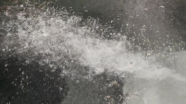 Close-up underwater bubbles from a pool jet pump creating abstract water motion for spa, wellness, luxury hospitality, hydrotherapy, science, and motion graphics.