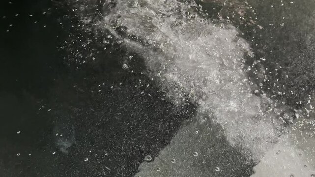 Abstract diagonal stream of pool jet bubbles creating dynamic underwater motion, ideal for wellness, spa, luxury hospitality, science, motion graphics, and aquatic backgrounds.