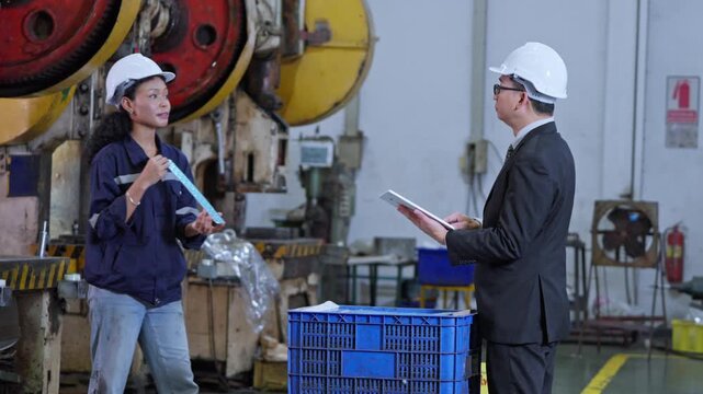 Engineers collaborating in a factory setting to enhance production efficiency and safety measures