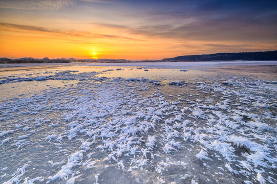 Beautiful winter sunrise over the frozen lake