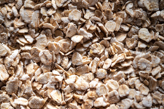 Full frame background texture of organic rolled oat flakes.Close-up view of healthy raw oatmeal flakes, nutritious whole grain breakfast ingredient
