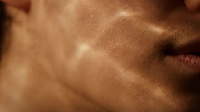 Close-up of a man's face with rippling light patterns on his skin