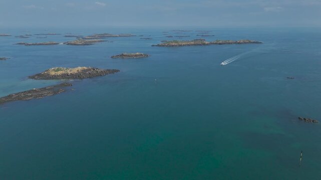Aerial view of a boat moving across the sea near Chausey, Normandy, France