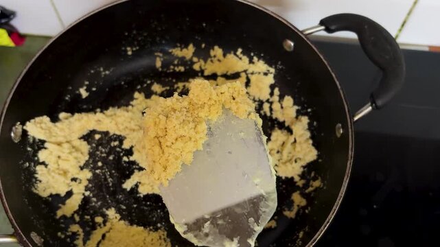Cooking Suji Halwa With Roasted Semolina In Nonstick Pan On Kitchen Stove