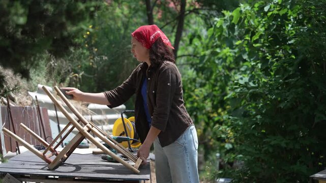 craftswoman refurbishing an old wooden chair, furniture repair, restoration and woodworking