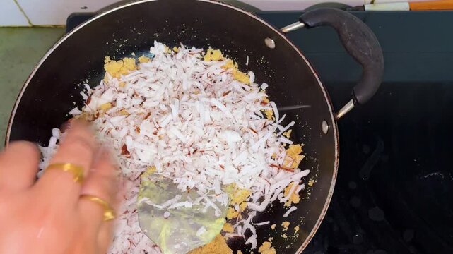 Grated Coconut And Jaggery Mixture Cooking In Pan For Traditional Indian Sweet Recipe