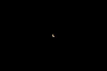 Crescent Moon in the Dark Night Sky with Visible Surface Details and Textures © Laura