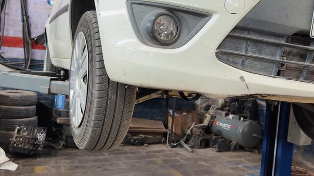 Vehicle Raised down on Hydraulic Lift after Routine Car Service and Maintenance