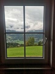 Obraz premium Scenic mountain view through a window with natural light