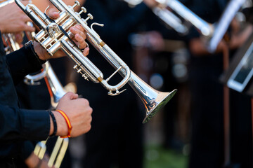 Fototapeta premium Spanish musician playing trumpet during street performance, holding instrument