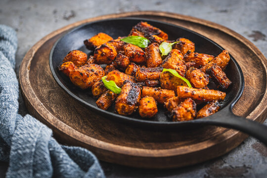 Delicious roasted carrots seasoned with herbs served in a cast iron skillet