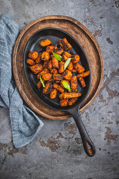 Delicious roasted carrots seasoned with herbs served in a cast iron skillet