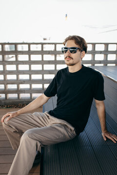 Man wearing black blank t-shirt with space for your logo or design. Mock up	
