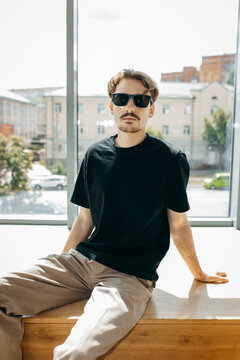 Man wearing black blank t-shirt with space for your logo or design. Mock up	
