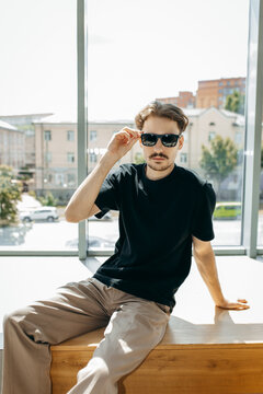 Man wearing black blank t-shirt with space for your logo or design. Mock up	
