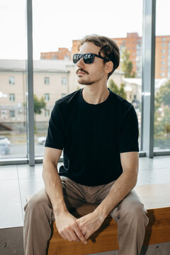 Man wearing black blank t-shirt with space for your logo or design. Mock up	
