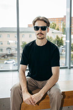 Man wearing black blank t-shirt with space for your logo or design. Mock up	

