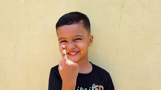 Boy Showing Inked Finger for Voting Awareness Activity and Representing Democratic Participation