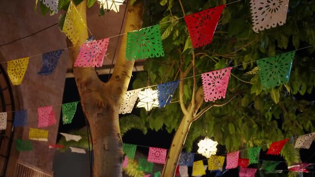 Mexican papel picado flags waving at night festival
