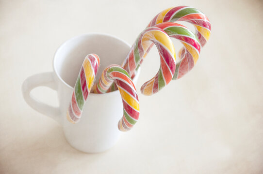 Close-up of Five multi coloured striped candy canes in a mug