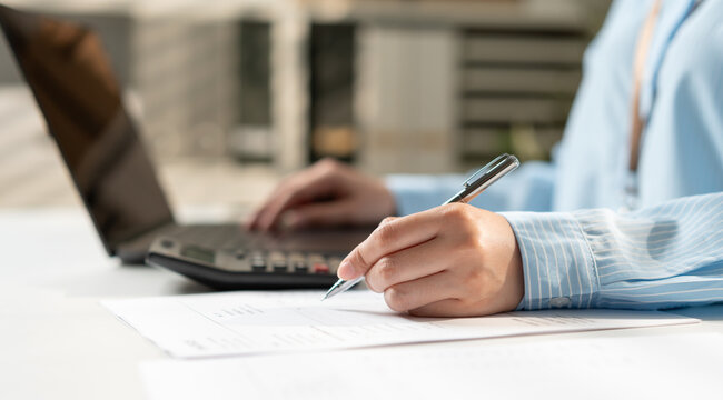 Businesswoman under check accountant for working on tax and finance, budget planning, payment processing, financial reporting and business accounting management concept.