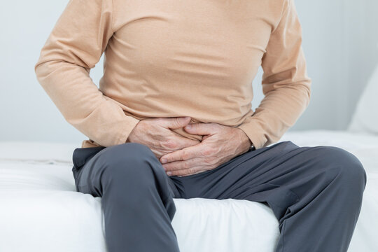Mature caucasian man touching his belly suffer from stomach ache