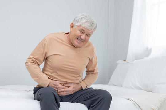 Mature caucasian man touching his belly suffer from stomach ache