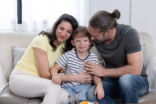 Family spends time together in living room during afternoon, sharing smiles and warmth