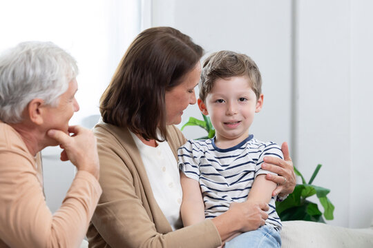 Family spends time together in living room during afternoon, sharing smiles and warmth