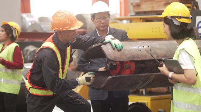 Close-up shot of an executive with a white safety helmet and a veteran technician inspecting steel components and machinery equipment. Demonstrating quality assurance, industrial maintenance, teamwork
