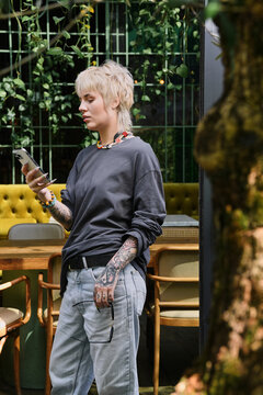 Stylish cozy day in a cafe for a young non binary person enjoying their time