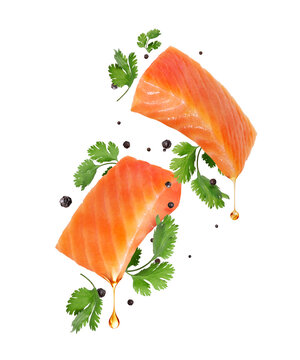 Salmon steaks with parsley and allspice close-up in the air isolated on a transparent background
