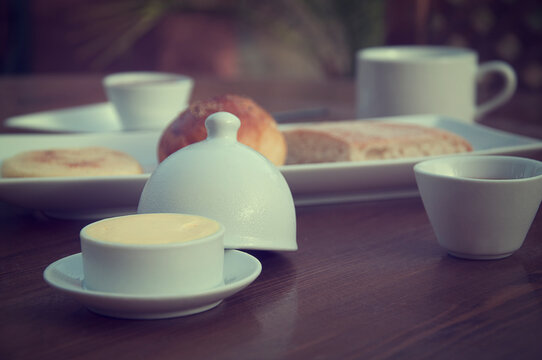 Close-up of bread, butter and tea on a table for breakfast