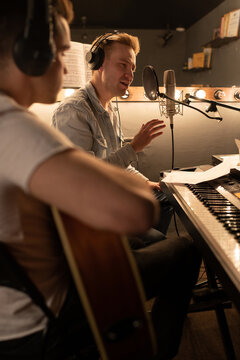 Professional musicians creating song in recording studio