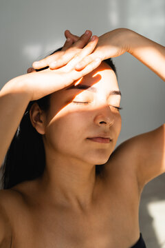 A young woman relaxing in the sun at home