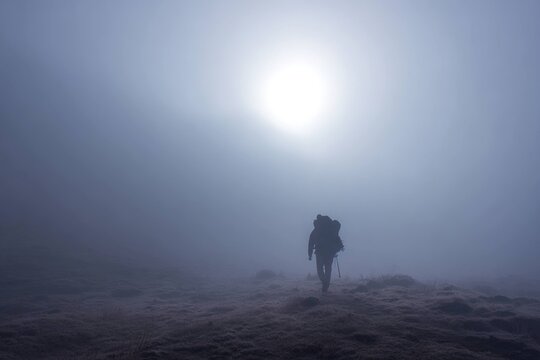 foggy morning trek with silhouette of backpacker