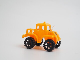Bright Yellow Plastic Toy Truck with Black Wheels, an Off-Road Vehicle Model, Isolated on a Clean White Background © Ditracreative