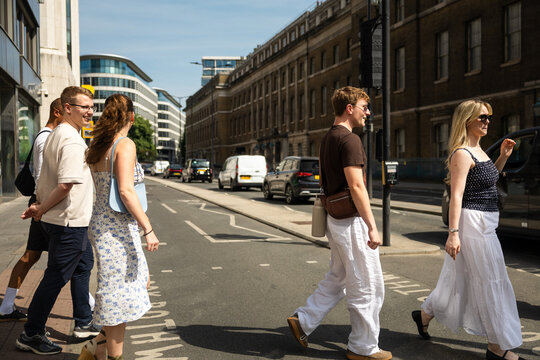 Friends crossing a street in central London