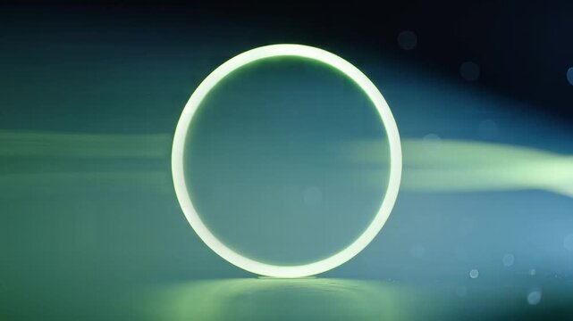 Green plant stalk inside glowing glass ring with sparkling bokeh effect on dark background