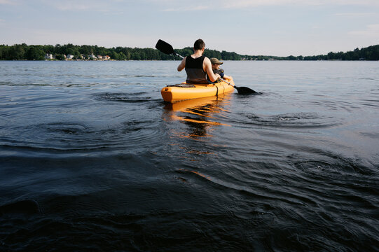 father and son in kayak on a lake in massachusetts in summer