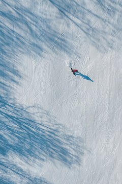Aerial View of Snowboarder Carving Down a Snowy Slope