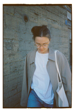 Woman walking on the street with a bag in the evening light