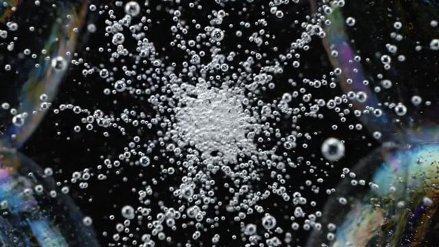 Air bubble water macro black abstract texture sparkling cluster iridescent liquid foam hexagon cell pattern glossy soap film dark center clean science close detail