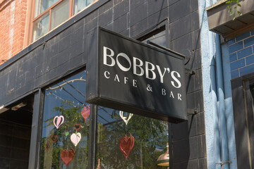 Obraz premium wall-mounted box sign outside Bobby's Breakfast Cafe & Bar, a brunch restaurant, located at 810 College St, Toronto
