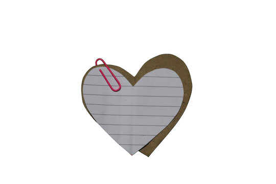Heart shaped torn paper note with lined paper and pink paperclip attached isolated on transparent background.