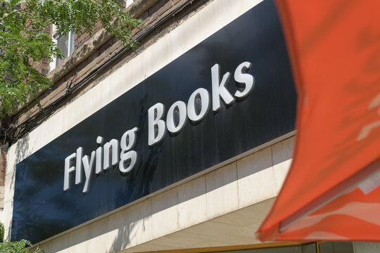 exterior building facade and sign of Flying Books, a book store, located here at 784 College St, Toronto