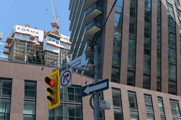 Obraz premium contrast of FORMA Toronto condominium complex (designed by Frank Gehry) and PJ Condos (99 John St) designed by Hariri Pontarini Architects